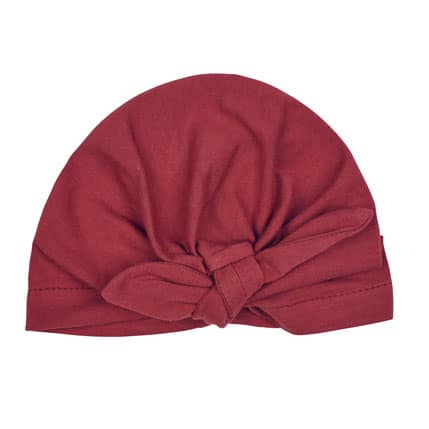 Bonnet naissance forme turban couleur tomette, vendu par Rêves de fil.